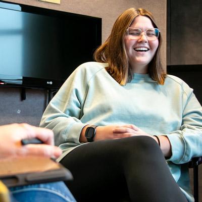 a student sits and laughs